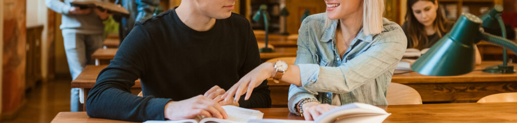 Studenci rozmawiający przy książce
